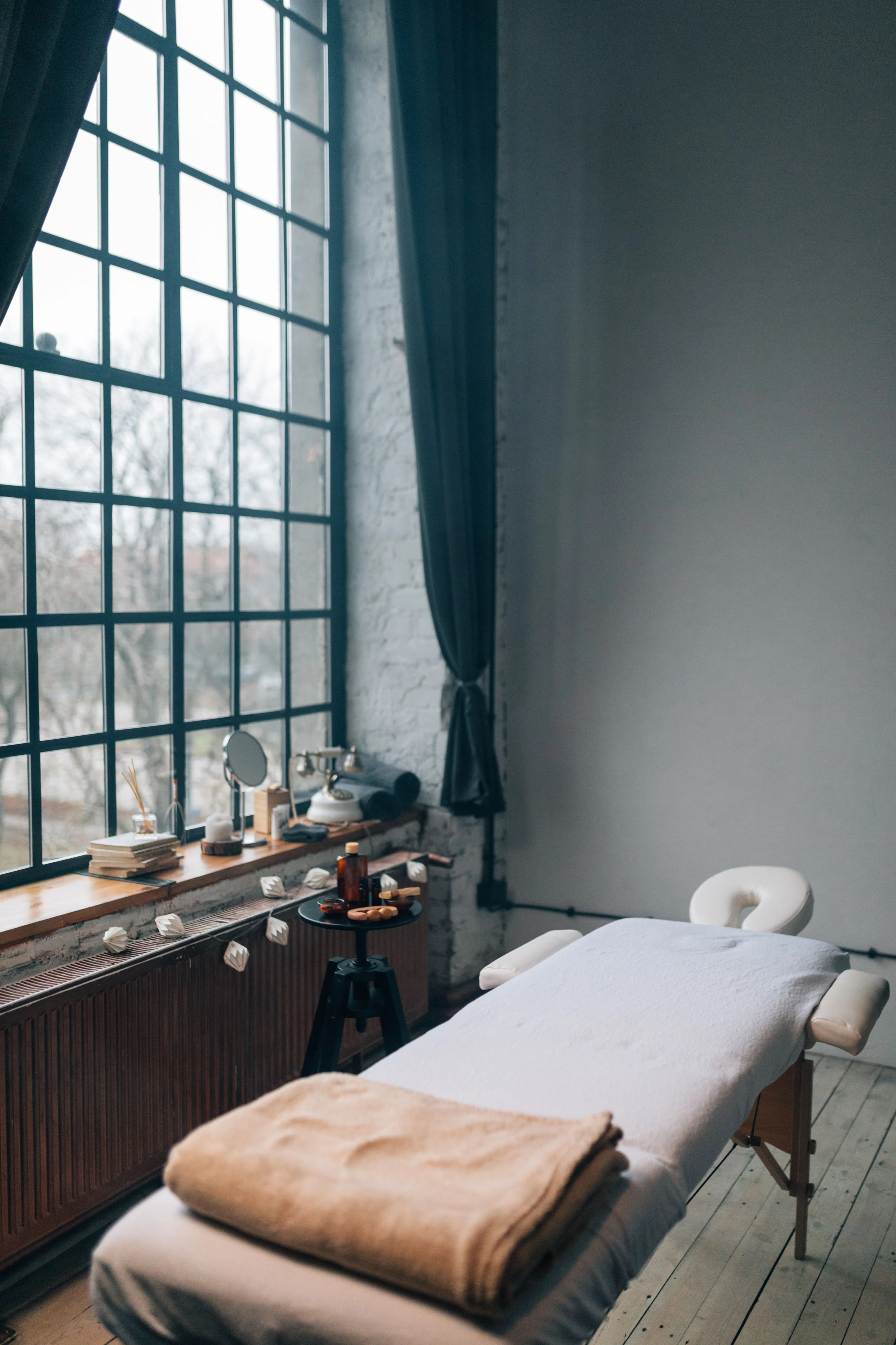 Calm day spa treatment room with natural light from large windows