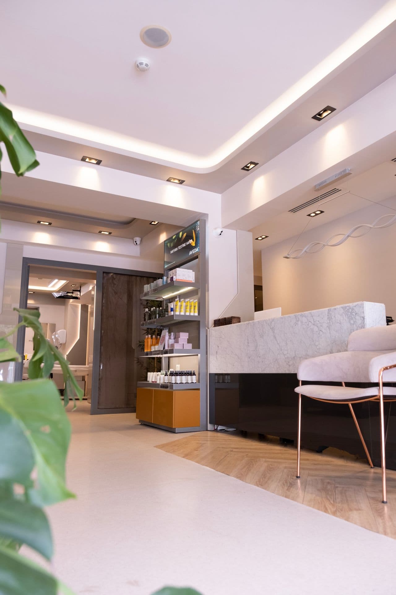 Marble reception desk and seating in a bright spa interior.