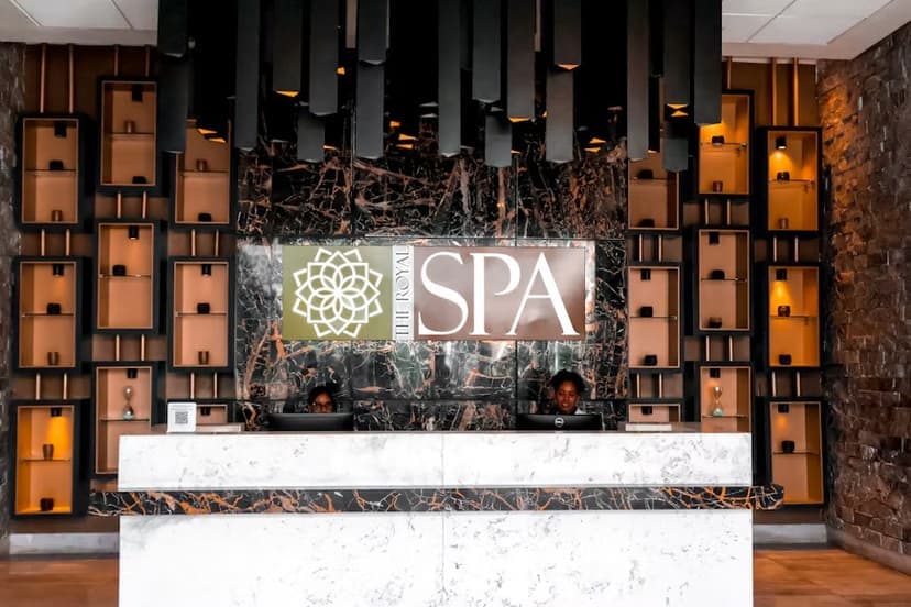 Reception desk at the Royalton Bavaro spa, with illuminated shelving and a marble counter